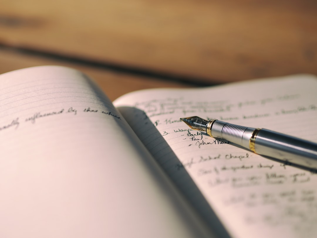 Fountain pen resting on handwritten notes