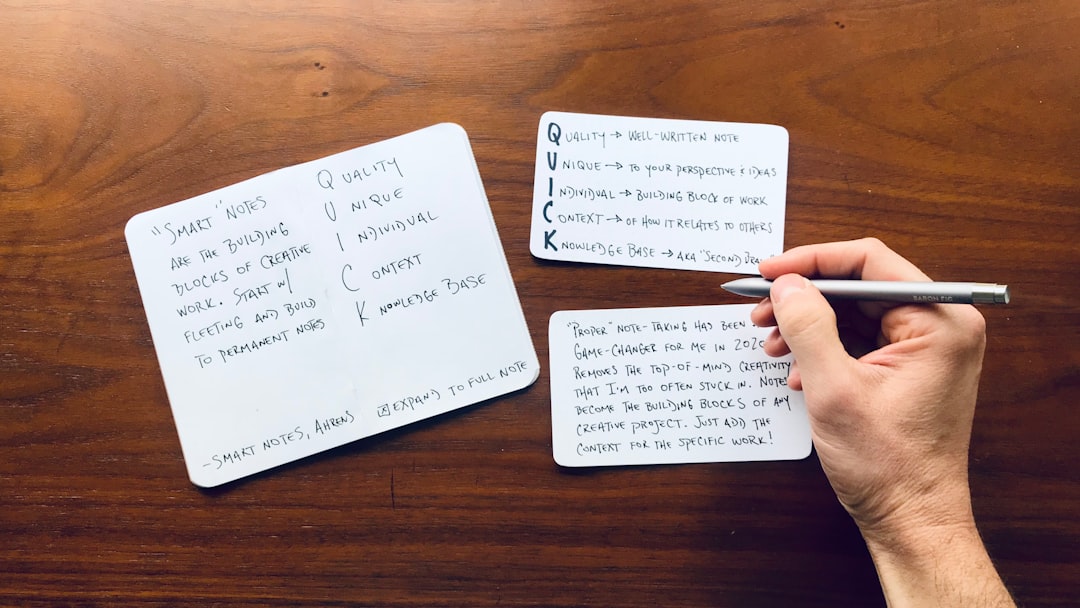 Handwritten index cards on a wooden desk